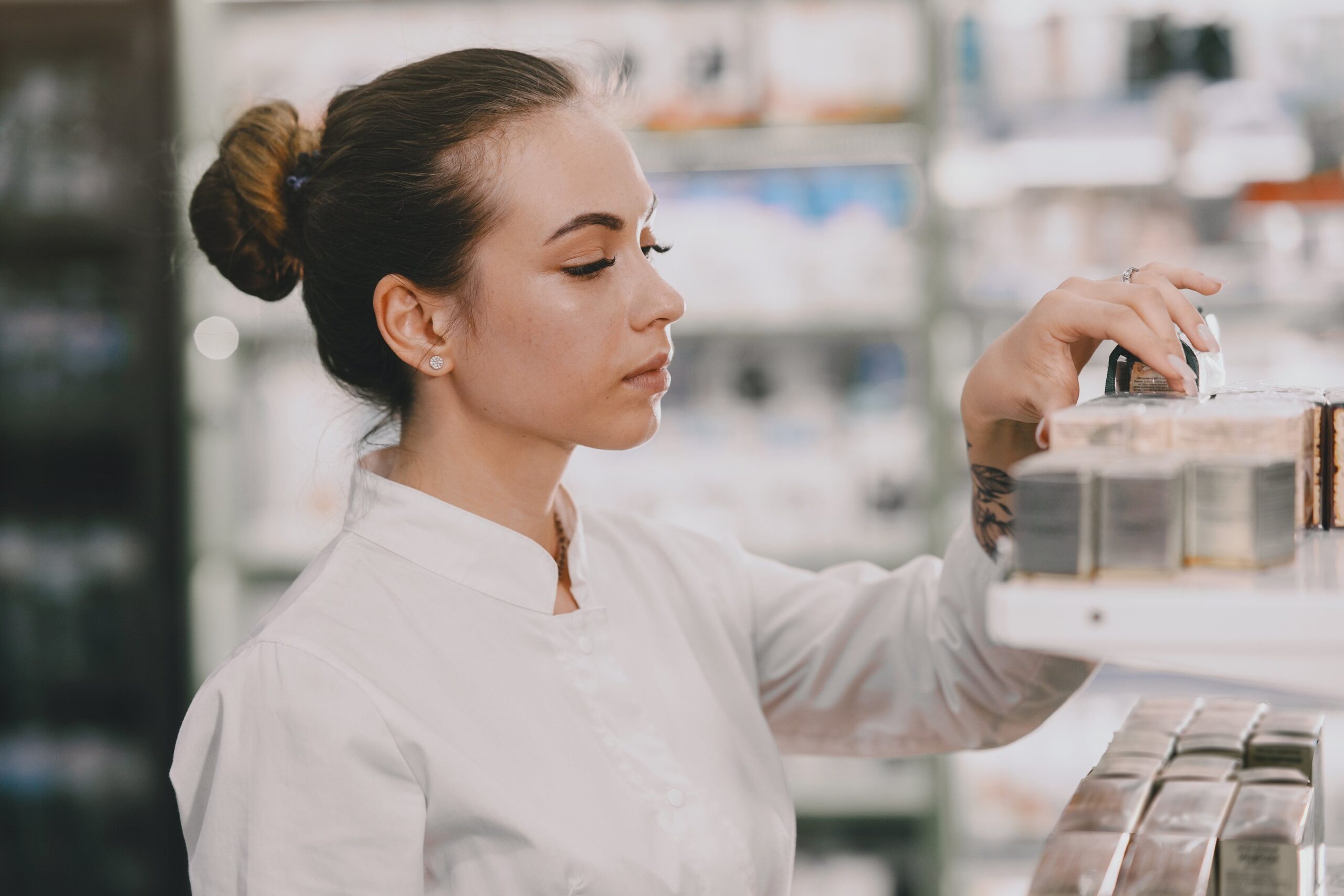 Woman checking an FSA-approved skincare product in a store aisle